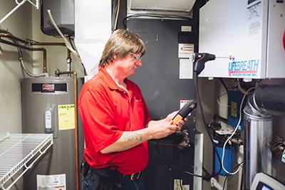 A Holt Plumbing and Heating technician taking static pressure readings