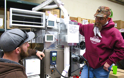 Ken Scott (right) and Jeffery Peck participate in a typical in-house training session conducted by Masterworks Mechanical weekly.