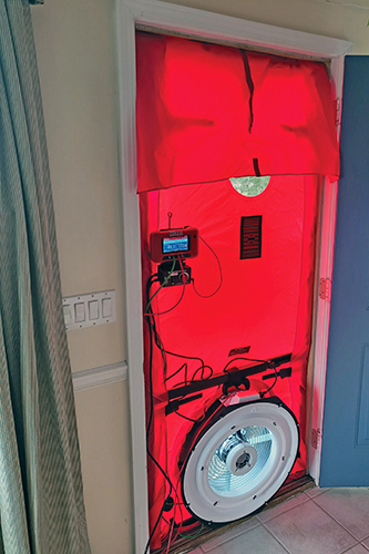 Testing the building envelope using a blower door.