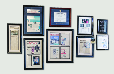 Company recognitions adorn Alana Ward's office.