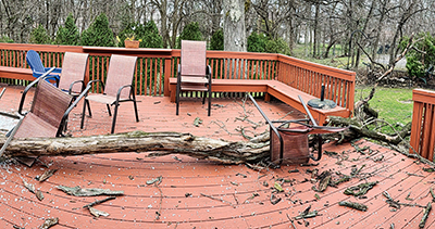 Great craftsmanship displayed in this photo of a deck surviving a giant tree limb crash with little to no damage.